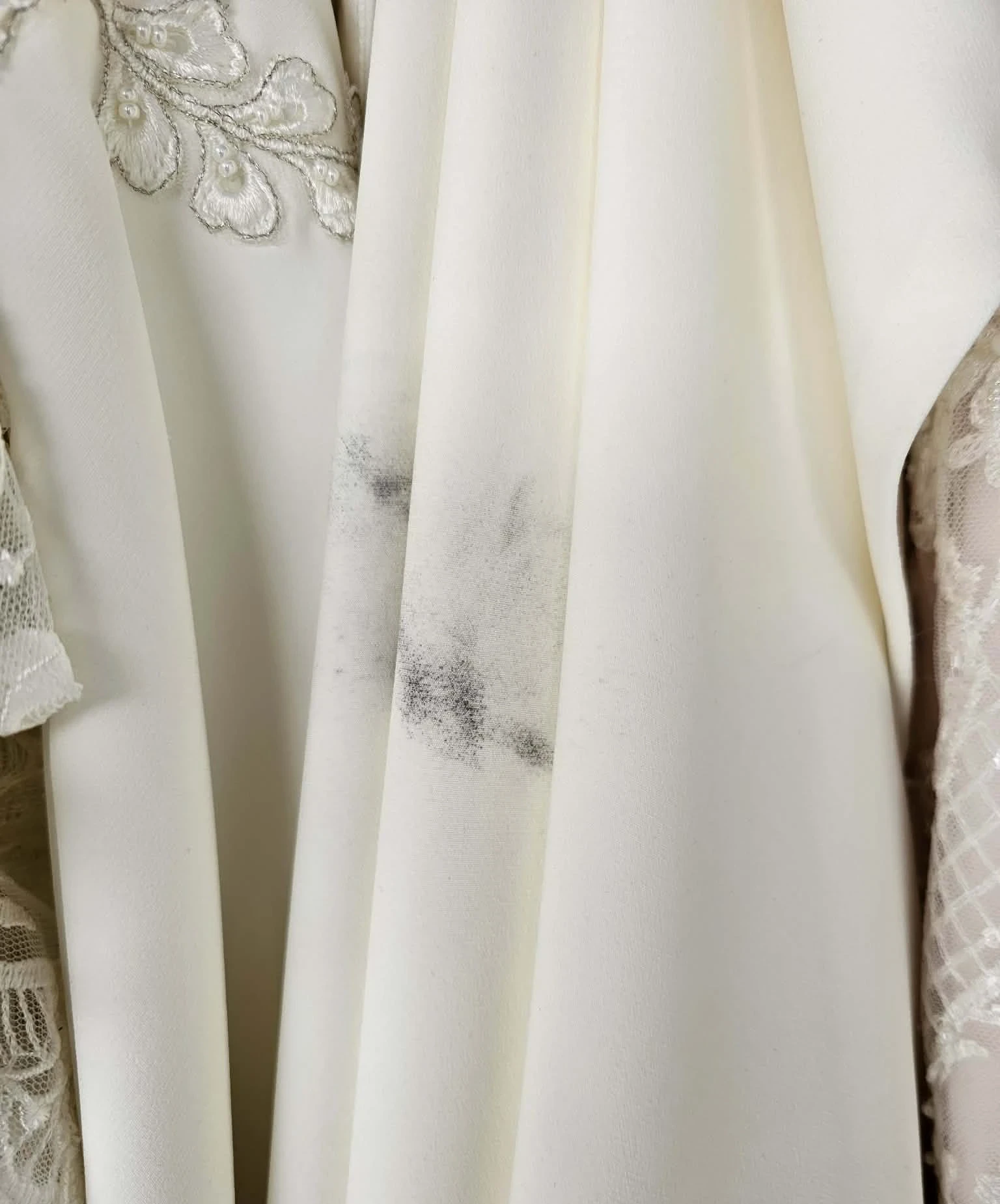 Close-up of grease stain on gown fabric