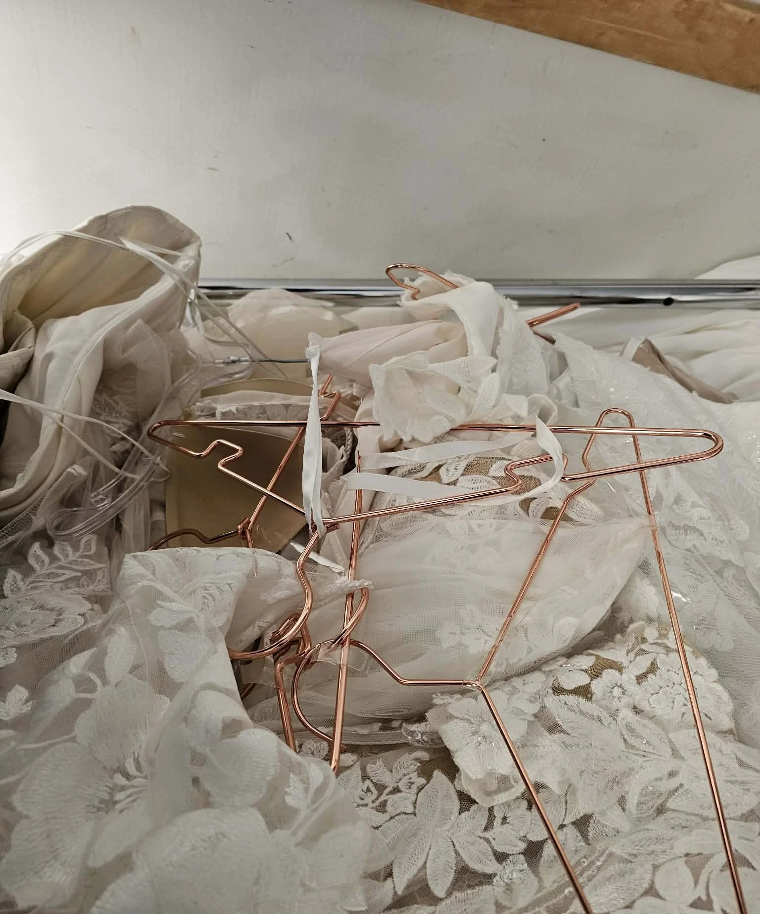 Copper hangers piled on gowns