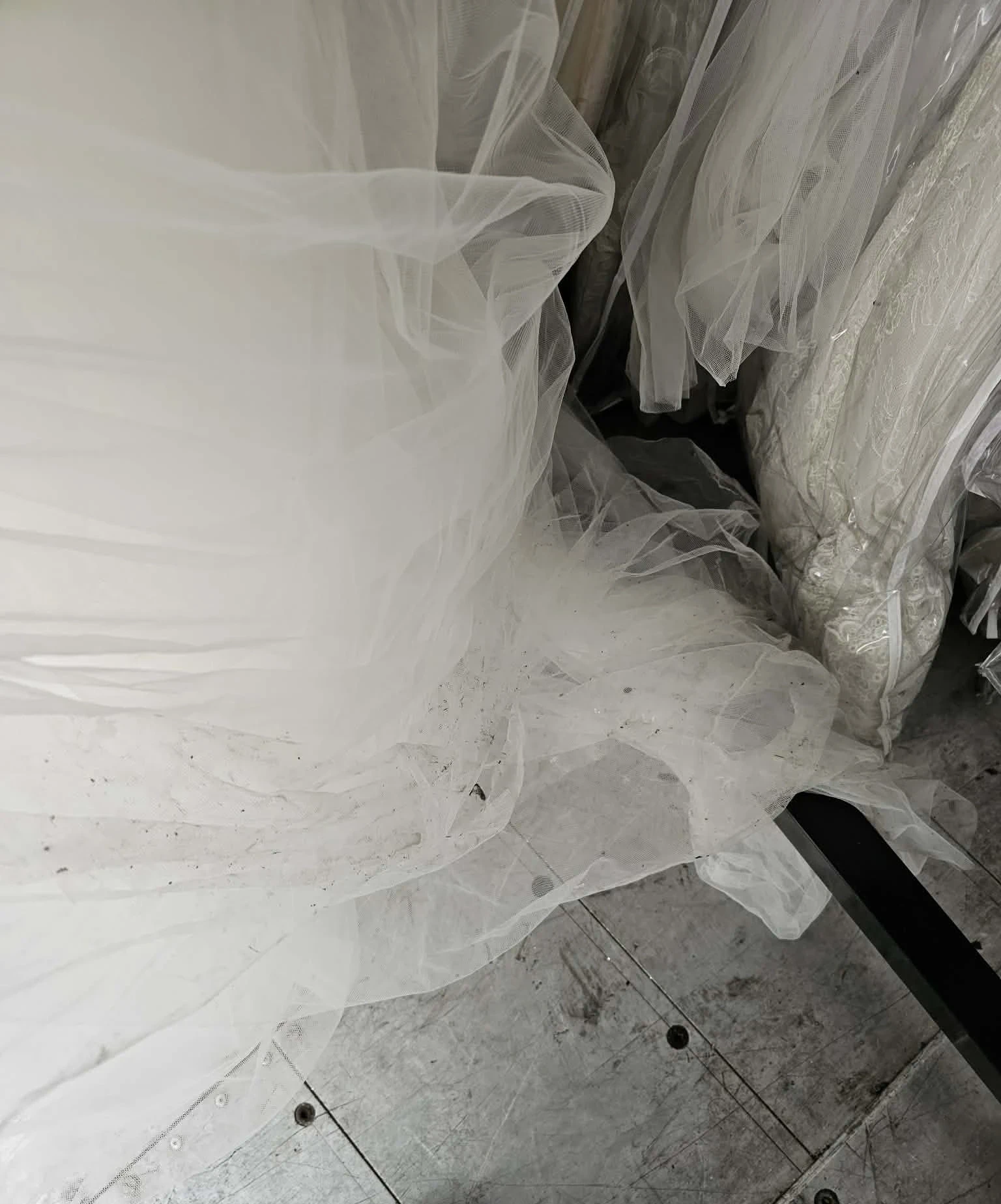 Soiled tulle dragging on floor