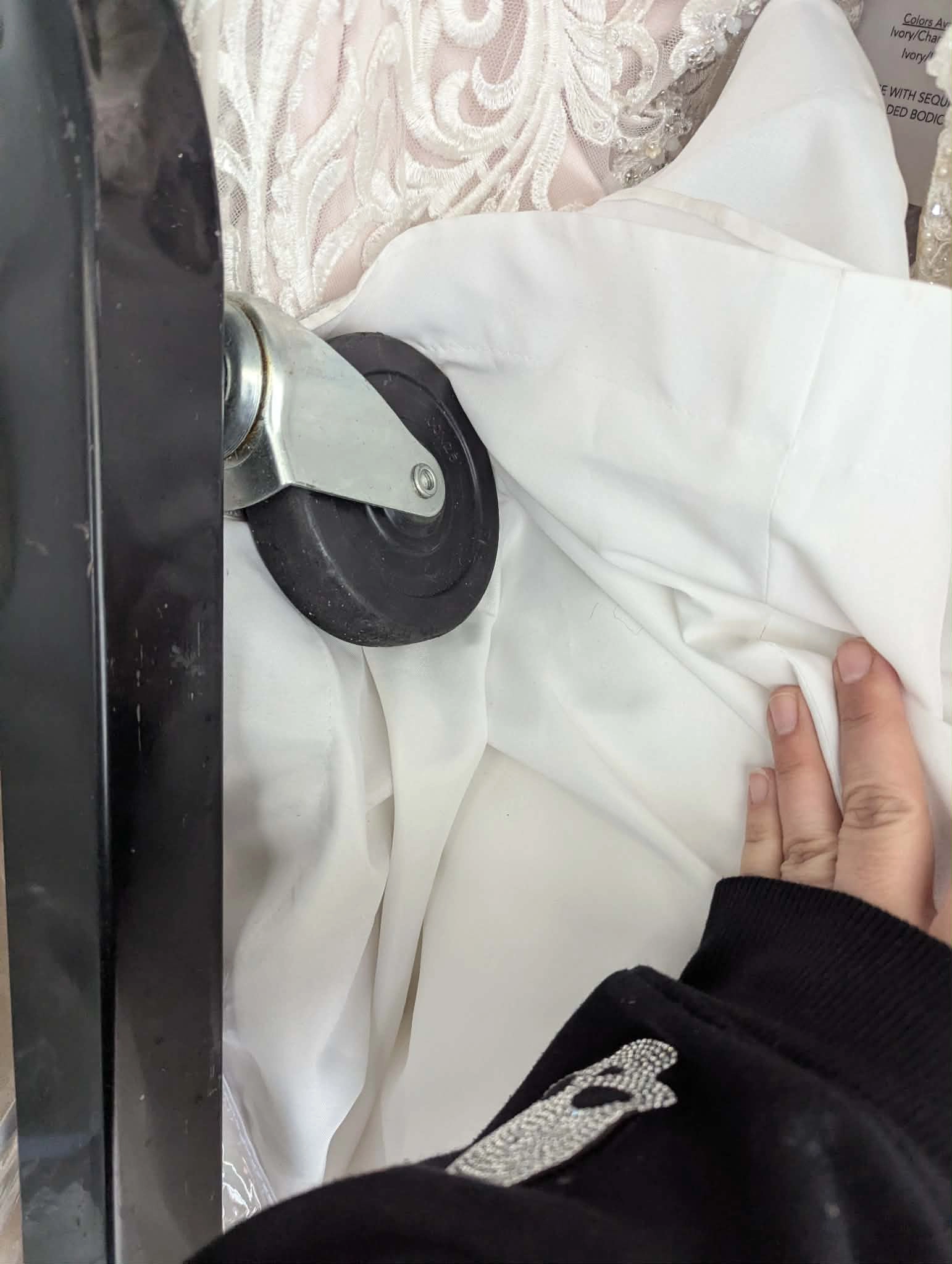 Gown fabric caught under rack wheel